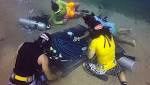 The chips are a long way down! Divers up the ante by playing a game of POKER on the ocean bed off Egypt